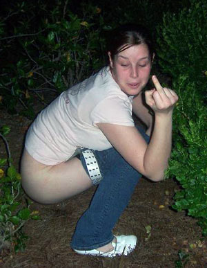 Young woman squatting on campus.