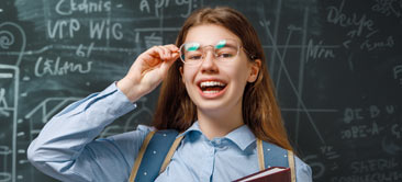 Enthusiastic math student in front of blackboard.